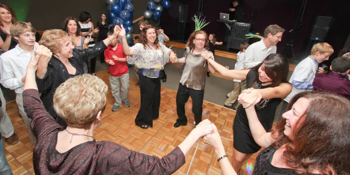 Jewish friends dancing on a dance floor
